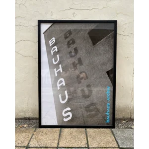 Framed official Bauhaus-Archiv Berlin poster featuring architectural low-angle black and white photography of the iconic Bauhaus building signage in a black wooden frame.