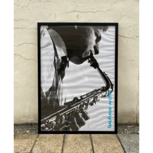 Official Bauhaus-Archiv Berlin poster featuring a close-up black and white photograph of a musician playing a saxophone, available unframed or framed in a black solid wooden frame.