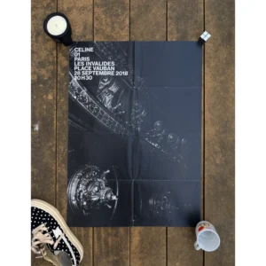 Official double-sided CELINE SS19 show invitation art poster by Hedi Slimane, featuring a dramatic monochrome photo of an elaborate baroque chandelier on one side, and an open metal mesh gate leading into a dark courtyard on the reverse, with white show text, measuring 72x56.5cm.