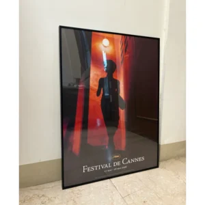 Official 2006 Cannes Film Festival poster featuring Maggie Cheung's silhouette from Wong Kar-wai's In the Mood for Love against a glowing red doorway, framed in a black aluminum frame, measuring 80x60cm.