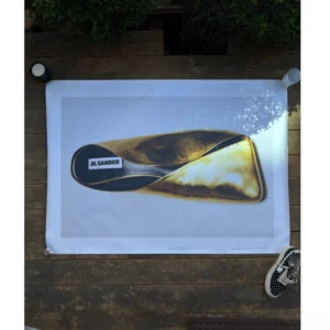 Official double-sided Jil Sander FW22 campaign poster featuring a sculpted golden shoe object on one side and a halftone starry galaxy on the reverse, measuring 137x98cm unframed.