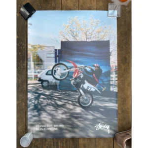 Official Stussy Fall 2016 Paris campaign poster photographed by Tyrone Lebon, featuring a rider performing a dirt bike wheelie in front of a blue backdrop, measuring 91x61cm.