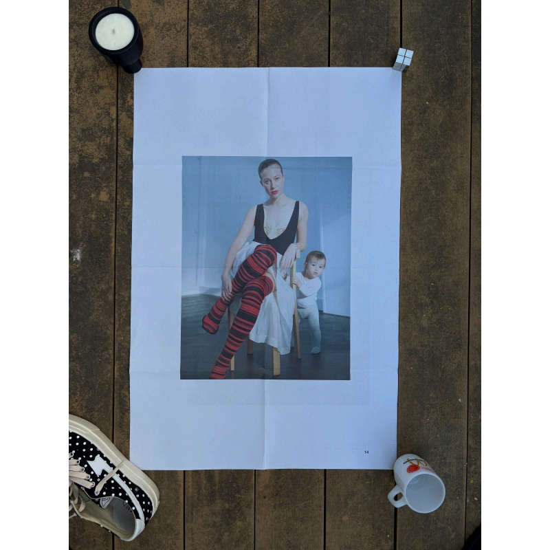 toga ss2023 1 2 Official double-sided TOGA S/S 2023 fashion poster shot by Liv Liberg, featuring a close-up portrait of a woman in a low-cut black dress on Side A, and the same woman seated with red striped tights beside a toddler on Side B, measuring 80.5x53cm.