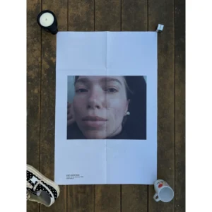Official TOGA S/S 2023 fashion poster shot by Zoë Ghertner, featuring an intimate extreme close-up portrait of a woman's face under natural light, measuring 80.5x53cm.